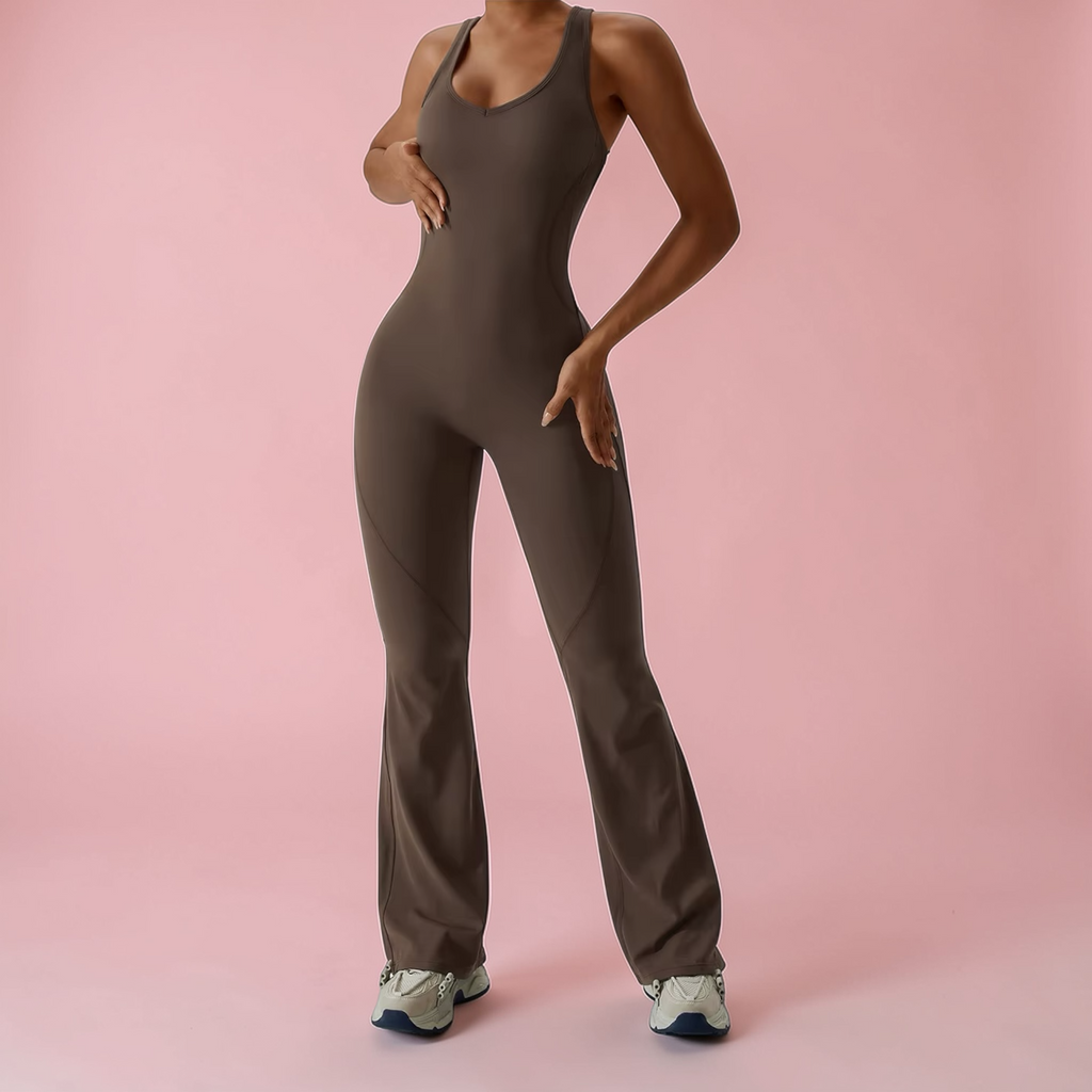 Person wearing a brown jumpsuit on a pink background