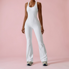 Person wearing a white jumpsuit on a pink background