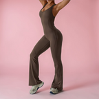 Person wearing a brown jumpsuit on a pink background