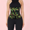 Green geometric patterned waist trainer worn by a person on a pink background