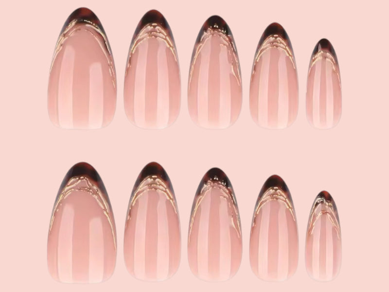 Set of nail extensions with a gold accent on a pink background