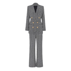 A two-piece blazer suit with a geometric pattern in gray and black, featuring a straight-cut design, gold-tone buttons, and pants to match.