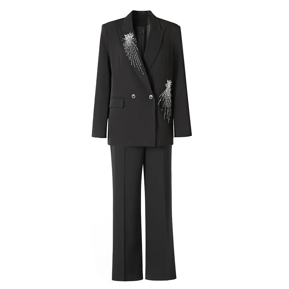 A black blazer with diamond beadings and a matching pair of pants, presented on a mannequin.